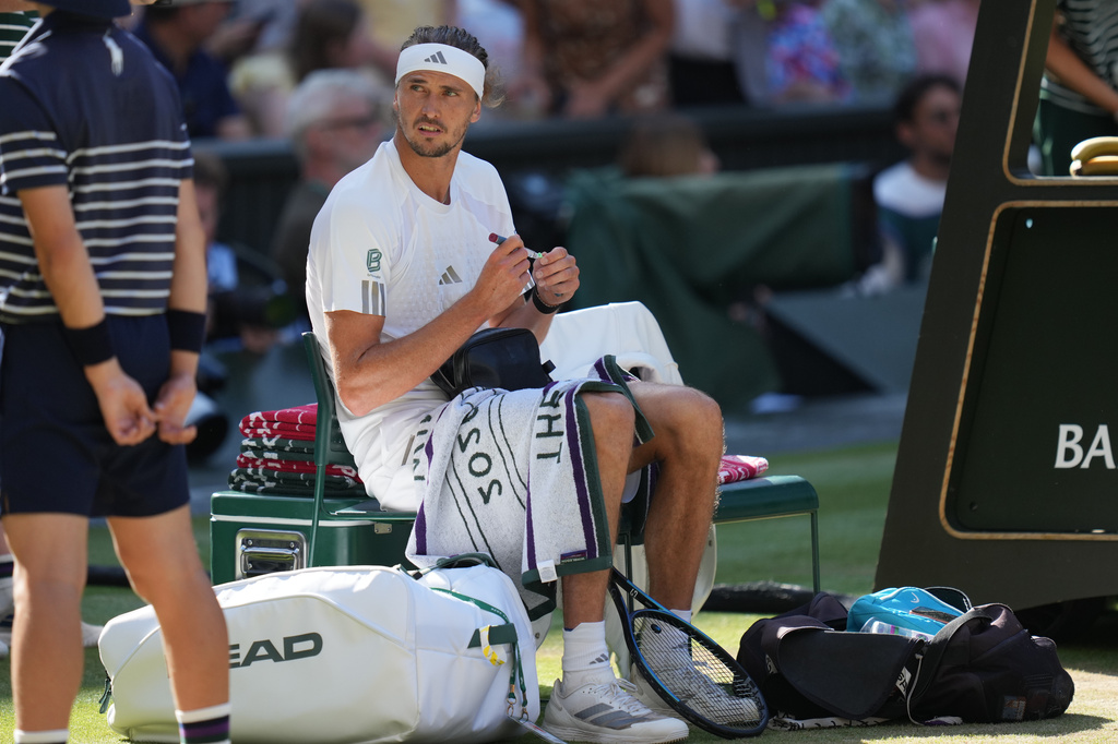 Alexander Zverev of Germany prepares to inject himself with insulin during a changeover in the men's singles final match against Jannik Sinner of Italy, at Wimbledon Tennis Championships in London, Sunday, July 12, 2026. (AP Photo/Kirsty Wigglesworth)