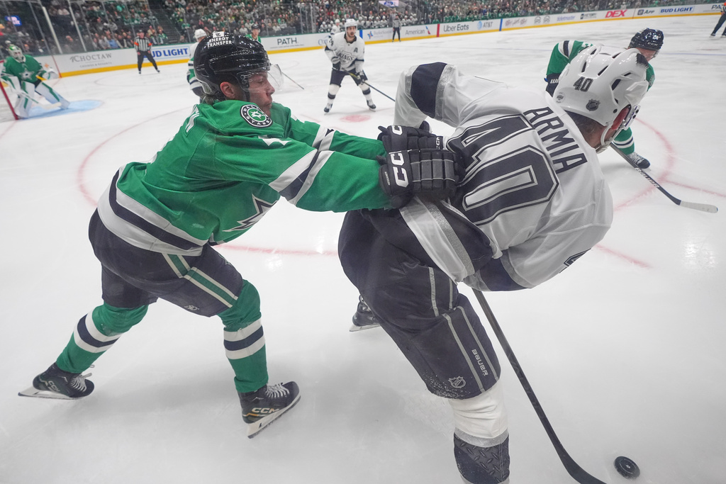 Dallas Stars defenseman Miro Heiskanen, left, pushes Los Angeles Kings right wing Joel Armia (40) during the second period of an NHL hockey game Thursday, Oct. 23, 2025, in Dallas. (AP Photo/LM Otero)