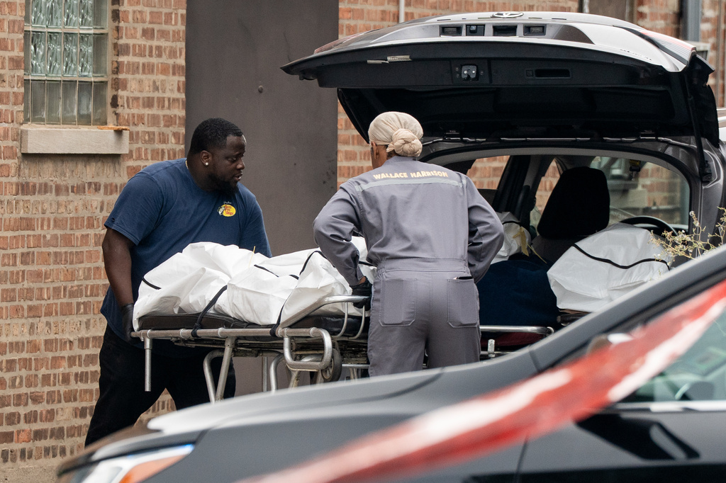 Workers load bodies into an SUV outside South Chicago Chapel on Friday, Aug. 7, 2026, after authorities found more than 50 bodies improperly stored at the funeral home during an investigation the previous night in Chicago. (Pat Nabong /Chicago Sun-Times via AP)