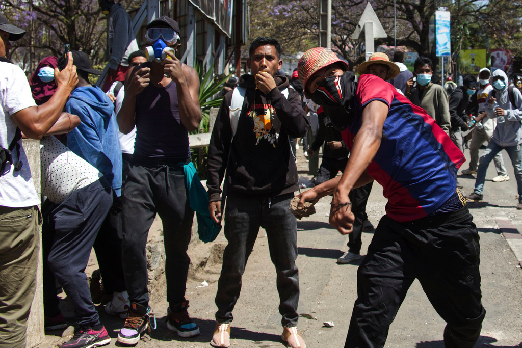 A man throws a stone during a protest calling for the president to step down in Antananarivo, Madagascar, Thursday, Oct. 9, 2025. (AP Photo/Alexander Joe)