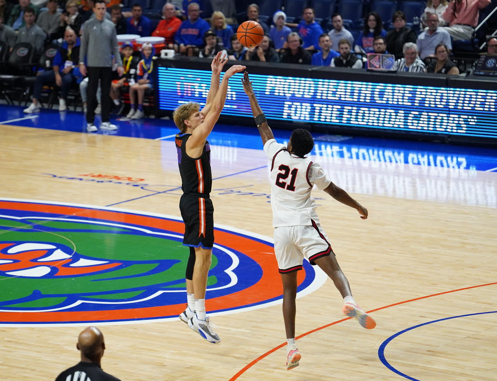 Florida forward Thomas Haugh (left) shoots a three-pointer against Saint Francis during the first half of an NCAA college basketball game Wednesday, Dec. 17, 2025, in Gainesville, Fla. (AP Photo/Morgan Hurd)