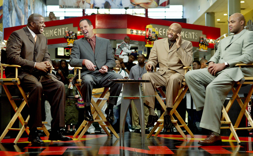 FILE - "Inside the NBA" hosts, from left, Earvin "Magic" Johnson, Ernie Johnson Jr., Kenny Smith, and Charles Barkley prepare for their live broadcast during TNT's NBA doubleheader coverage on Feb. 10, 2004, in the Compton section of Los Angeles. (AP Photo/Ric Francis, File)
