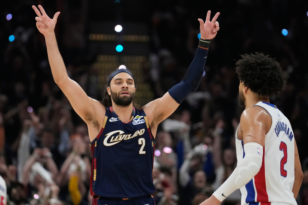 Cleveland Cavaliers Max Strus (2) celebrates a three-point basket in front of Detroit Pistons' Cade Cunningham, right, in the first half of Game 6 of a second-round NBA basketball playoffs series Friday, May 15, 2026, in Cleveland. (AP Photo/Sue Ogrocki)