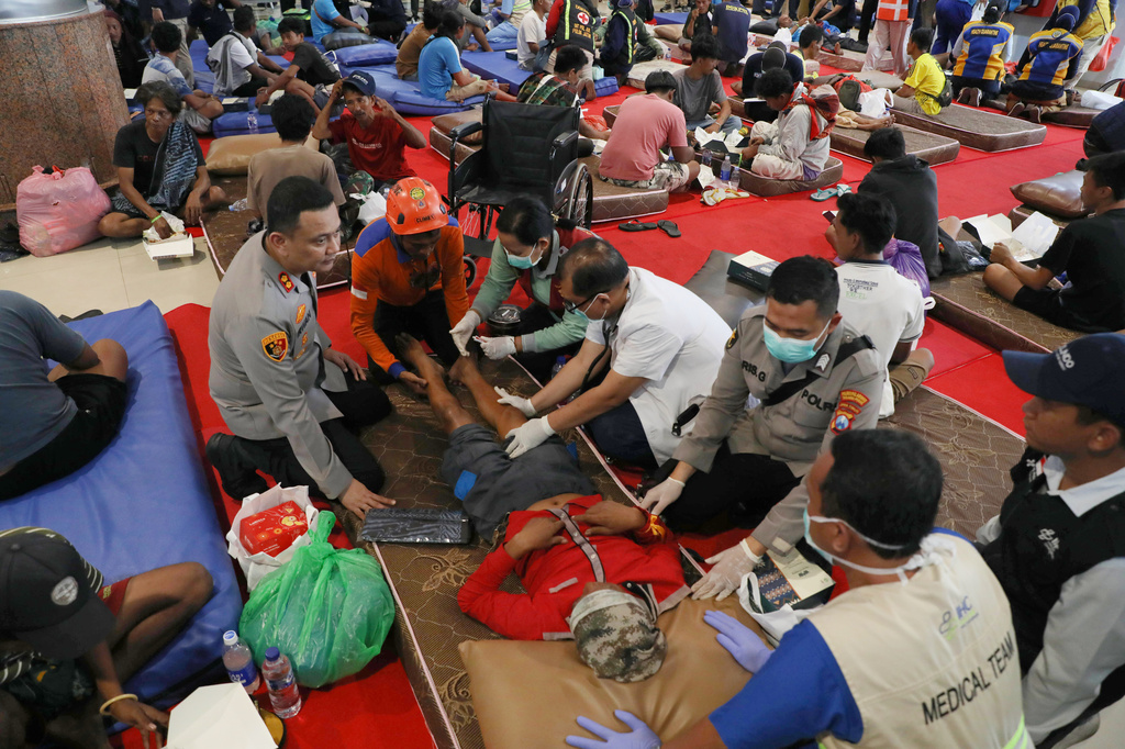 A survivor of a ferry fire receives medical treatment after arrival at Tanjung Perak Port in Surabaya, East Java, Indonesia, Tuesday, Aug. 4, 2026. (AP Photo/Trisnadi)
