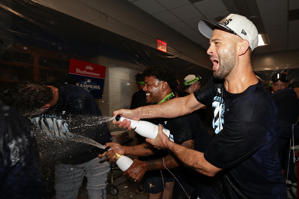 Tampa Bay Rays pitcher Nick Martinez celebrates in the locker room after the Rays defeated the New York Yankees to win the AL East Division after the second baseball game of a doubleheader Tuesday, Sept. 22, 2026, in New York. (AP Photo/Adam Hunger)
