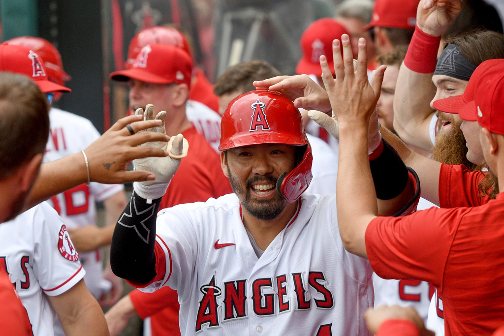 FILE - Los Angeles Angels' Kurt Suzuki (24) is congratulated in the dugout after hitting a solo home run during the second inning of a baseball game against the Seattle Mariners, Sunday, Sept. 26, 2021, in Anaheim, Calif. (AP Photo/Michael Owen Baker, File)
