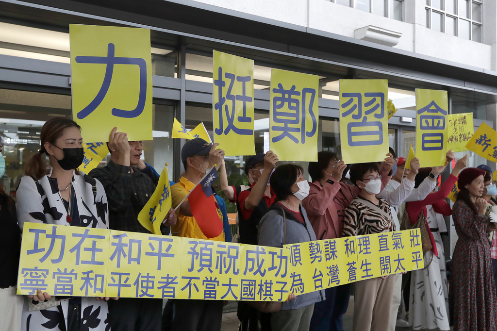 Supporters hold slogans reading ''Support Cheng Li-wun'' before Taiwan's main opposition Nationalist Party, or Kuomintang (KMT) chairperson Cheng Li-wun leaves for China outside of Taipei Songshan Airport in Taipei, Taiwan, Tuesday, April 7, 2026. (AP Photo/Chiang Ying-ying)