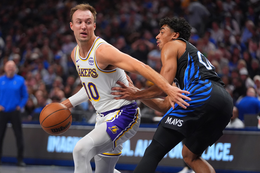 Los Angeles Lakers guard Luke Kennard (10) dribbles against Dallas Mavericks guard Max Christie (00) during the first half of an NBA basketball game in Dallas, Sunday, April 5, 2026. (AP Photo/LM Otero)