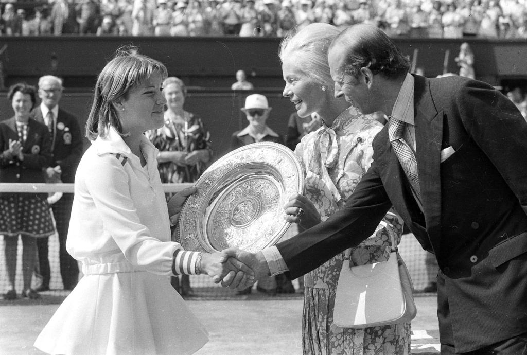 FILE - Chris Evert shakes hands with the Duke of Kent, right, while the Duchess of Kent, presents her with the winner's trophy, after she beat Australia's Evonne Goolagong Cawley in the final of the Women's Singles championship on July 2, 1976. (AP Photo/Bob Dear, File)