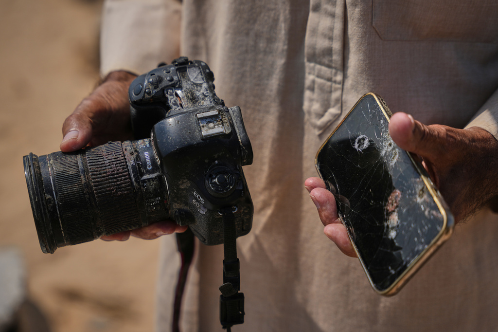 Riyad Abu Dagga, 69, displays the camera and phone belonging to his slain daughter, Mariam Dagga, a freelance journalist who worked with The Associated Press and other news outlets during the Gaza war and was killed in an Israeli airstrike on the Nasser Hospital building in Khan Younis on Aug. 25, 2025, in Khan Younis, Gaza Strip, Aug. 16, 2026. (AP Photo/Abdel Kareem Hana)