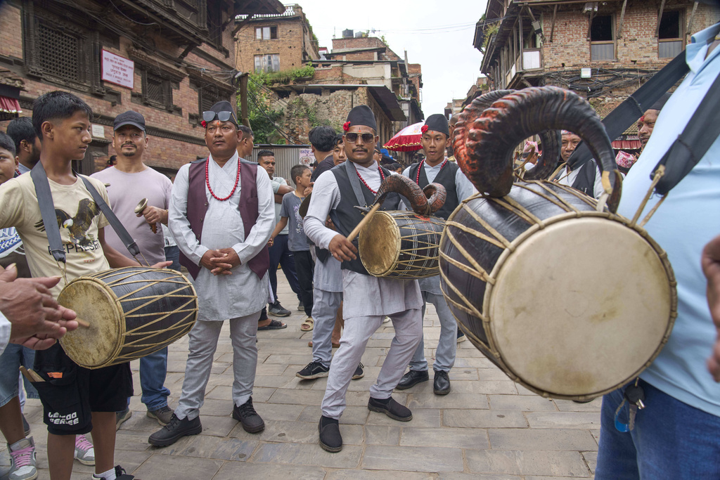 Devotees play traditional instruments during a parade celebrating the birthday of Lord Krishna on Krishna Janmashtami in Bhaktapur, Nepal, Saturday, Aug. 16, 2025. (AP Photo/Niranjan Shrestha)