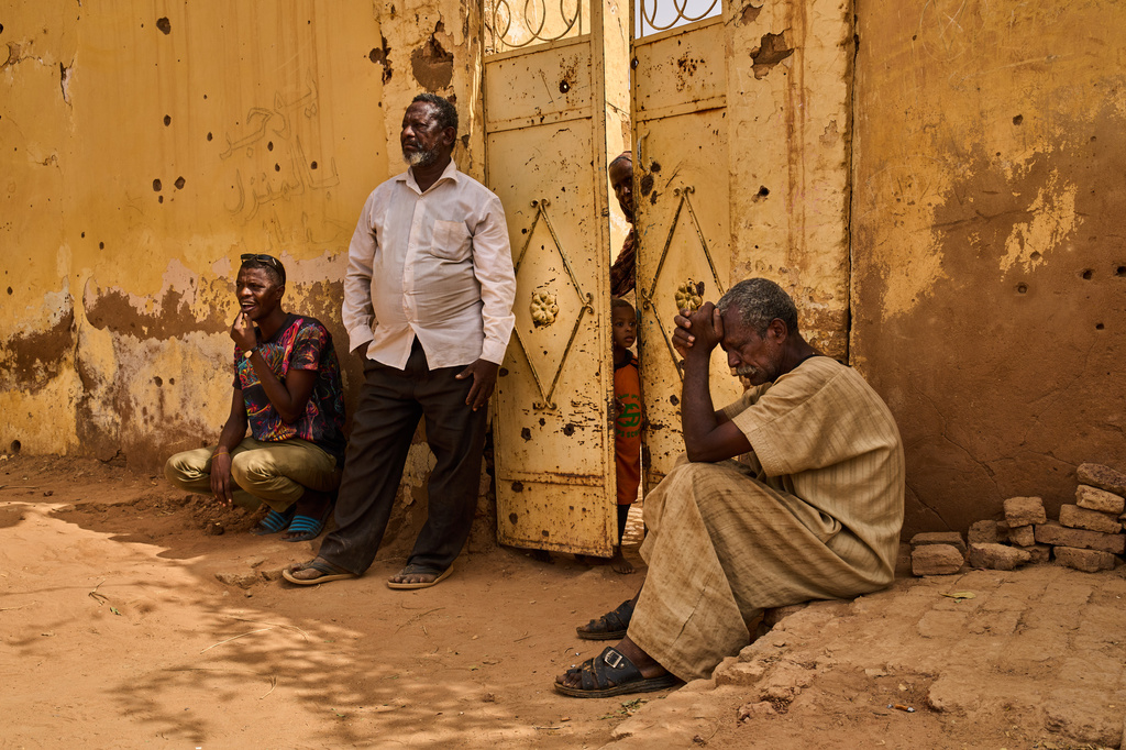 Abubakr Alsawi, right, waits during the exhumation of his brother Mohammed Alsawi, 73, who was killed in 2023 by the paramilitary group Rapid Support Forces, or RSF, in Omdurman, on the outskirts of Khartoum, Sudan, Monday, April 20, 2026. (AP Photo/Bernat Armangue)