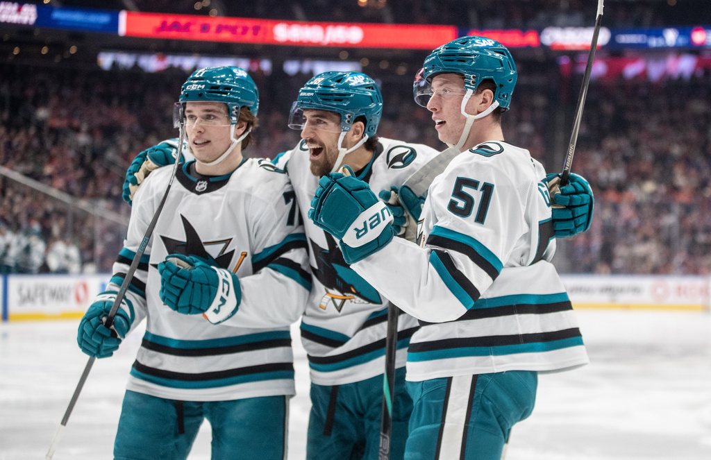 From left to right, San Jose Sharks' Macklin Celebrini, Mario Ferraro and Collin Graf celebrate after a goal against the Edmonton Oilers during first-period NHL hockey game action in Edmonton, Alberta, Thursday, Jan. 29, 2026. (Jason Franson/The Canadian Press via AP)