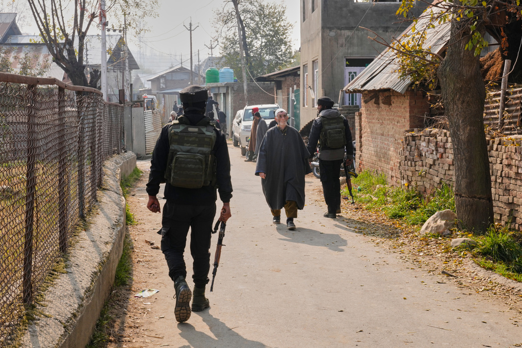FILE - Indian army soldiers patrol outside near the blown-up home of one of the key suspect behind the Nov. 10 Delhi car blast, in Pulwama, south of Srinagar, Indian controlled Kashmir, on Nov. 14, 2025. (AP Photo/Dar Yasin, File)