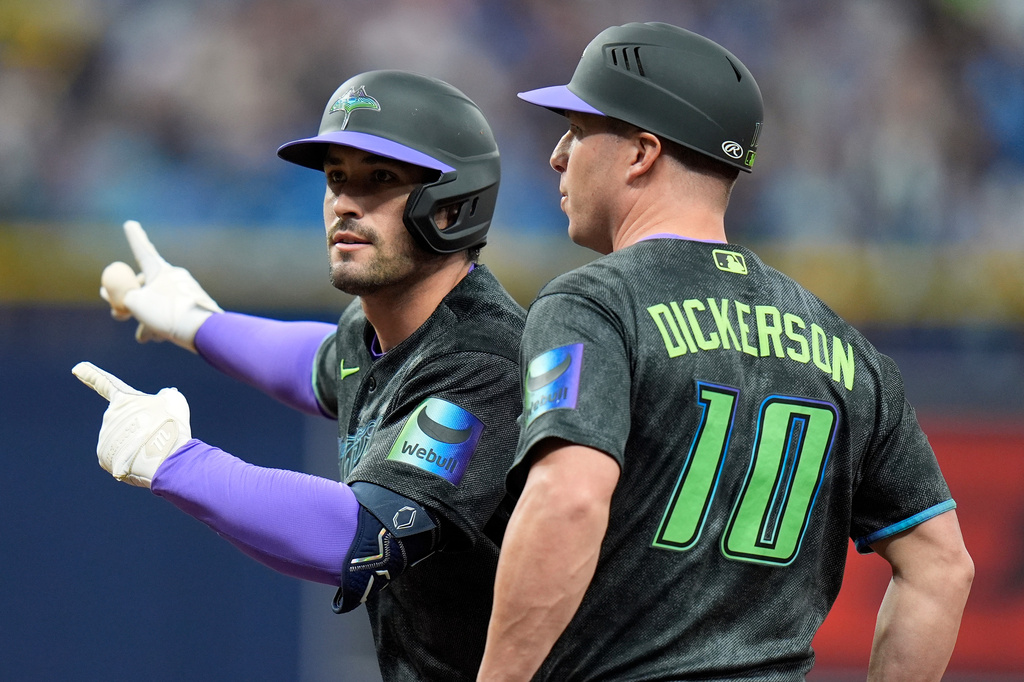 Tampa Bay Rays' Nick Fortes, left, celebrates his RBI single off Miami Marlins pitcher Pete Fairbanks with first base coach Corey Dickerson during the ninth inning of a baseball game Saturday, May 16, 2026, in St. Petersburg, Fla. (AP Photo/Chris O'Meara)