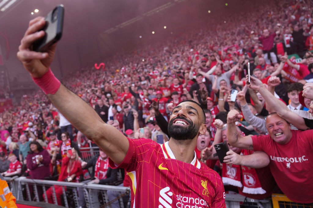 FILE - Liverpool's Mohamed Salah celebrates by taking a selfie after winning the English Premier League soccer match between Liverpool and Tottenham Hotspur and clinching the Premier League title at Anfield in Liverpool, England, April 27, 2025. (AP Photo/Jon Super, File)