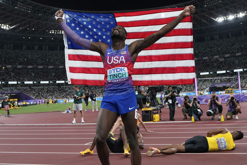 United States' Cordell Tinch celebrates after winning gold medal in men's 110 meters hurdles final at the World Athletics Championships in Tokyo, Tuesday, Sept. 16, 2025. (AP Photo/Eugene Hoshiko)