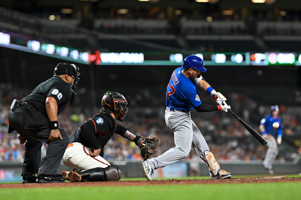 Chicago Cubs designated hitter Seiya Suzuki hits a three-run home run off Baltimore Orioles pitcher Grant Wolfram which scored Pete Crow-Armstrong and Michael Busch during the seventh inning of a baseball game, Wednesday, July 8, 2026, in Baltimore. (AP Photo/Terrance Williams)