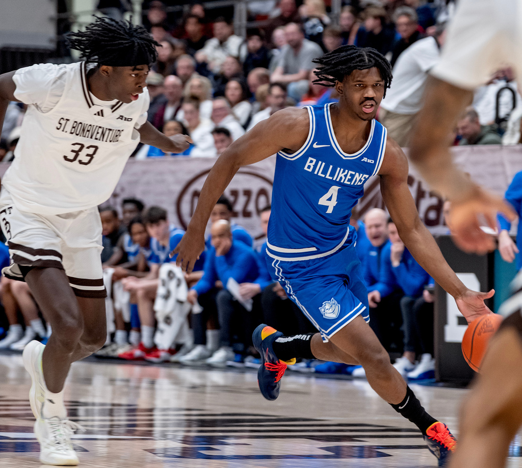 St. Bonaventure center Andrew Osasuyi (33) chases Saint Louis guard Amari McCottry (4) as they battle during the first half of an NCAA college basketball game Friday, Jan. 23, 2026, in St. Bonaventure, N.Y. (AP Photo/Craig Ruttle)
