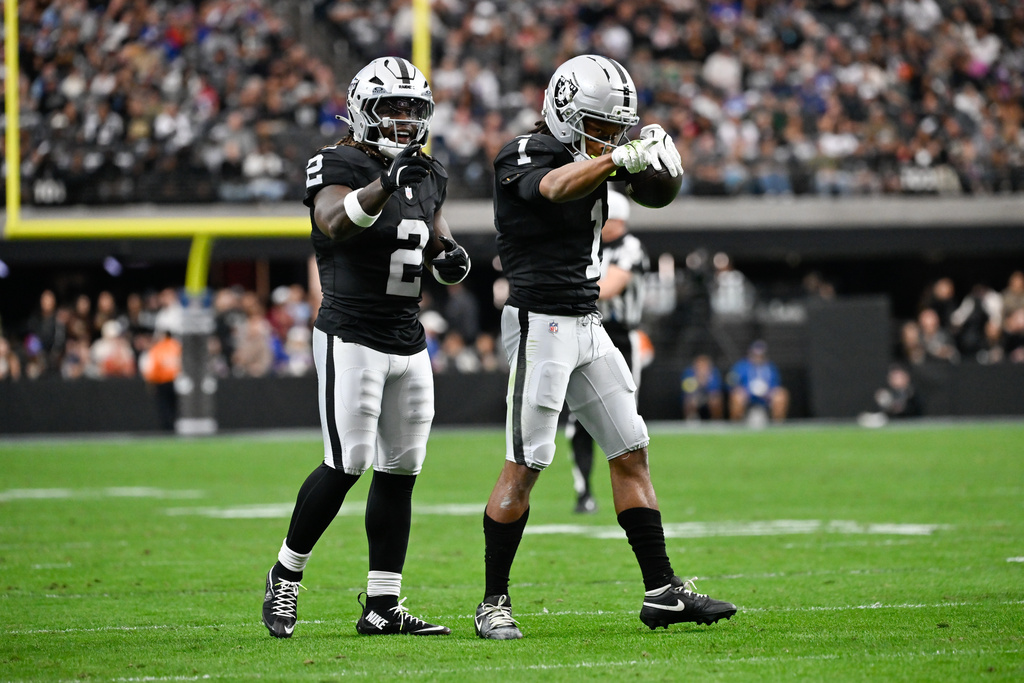 Las Vegas Raiders wide receiver Tre Tucker (1) celebrates his catch with running back Ashton Jeanty (2) during the first half of an NFL football game against the New York Giants Sunday, Dec. 28, 2025, in Las Vegas. (AP Photo/David Becker)