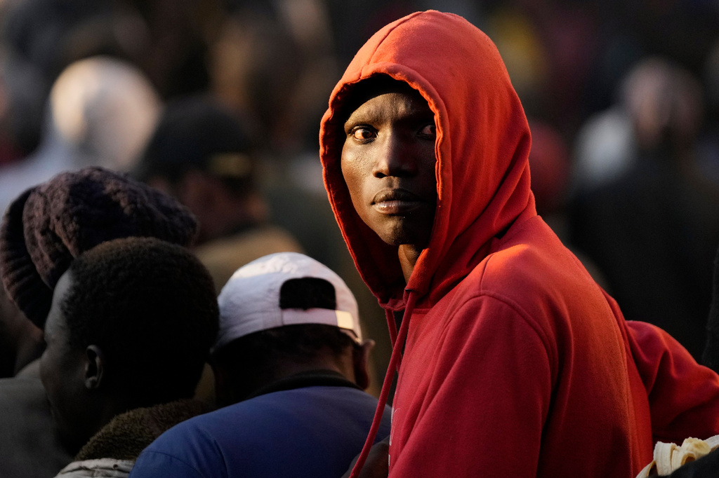 FILE - A Malawian migrant stands in a queue ahead deportation at a temporary centre in Durban, South Africa, Friday, June 19, 2026. (AP Photo/Themba Hadebe, file)