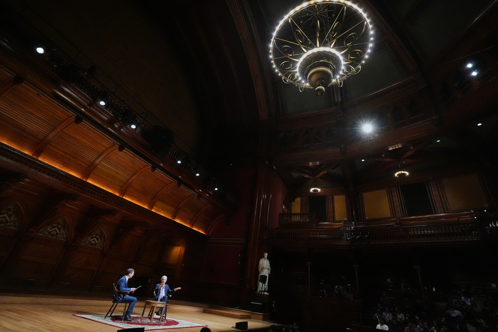 Federal Reserve Chair Jerome Powell, seated at right, gestures while addressing students with economics professor David Laibson at Harvard University, Monday, March 30, 2026, in Cambridge, Mass. (AP Photo/Charles Krupa)