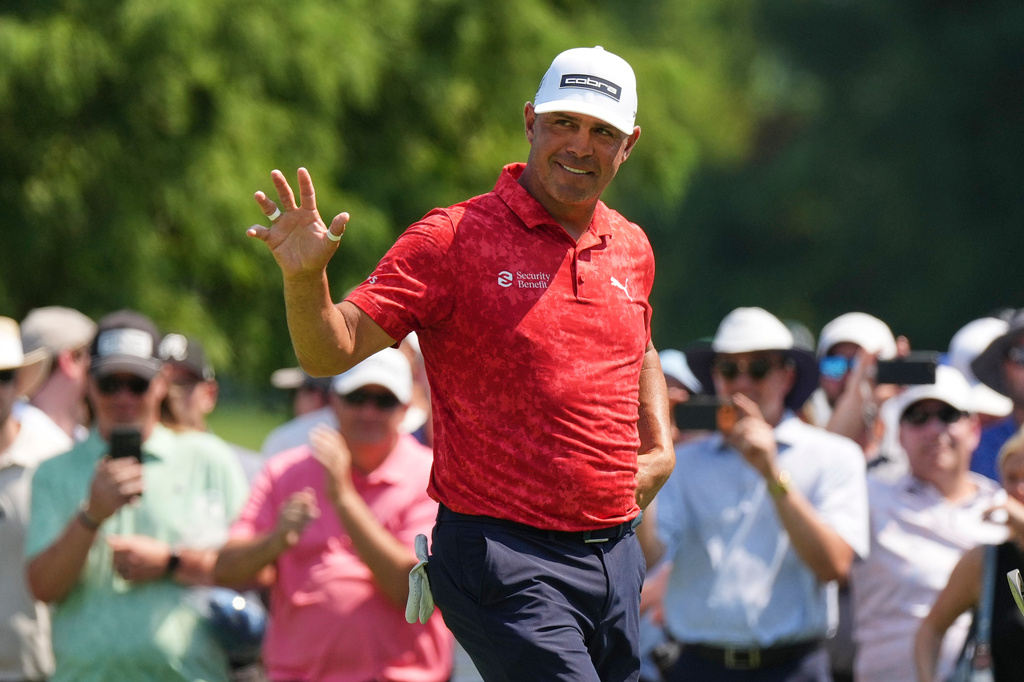 Gary Woodland waves after making a putt on the seventh green during the third round of the BMW Championship golf tournament Saturday, Aug. 22, 2026, in St. Louis. (AP Photo/Jeff Roberson)