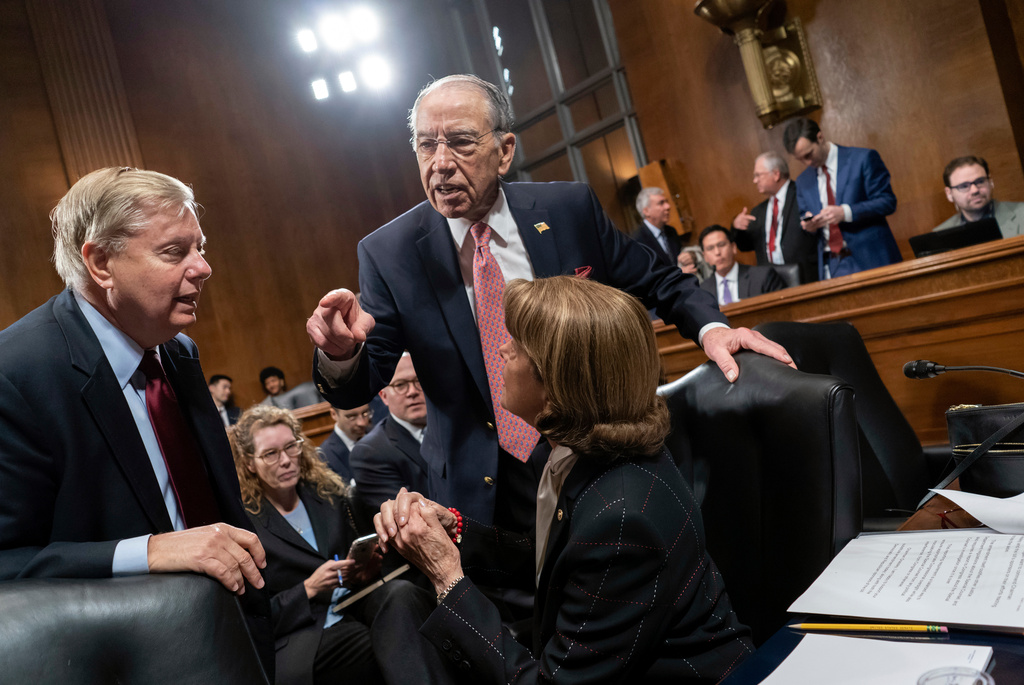 FILE - From left, Sen. Lindsey Graham, R-S.C., Senate Judiciary Committee Chairman Chuck Grassley, R-Iowa, and Sen. Dianne Feinstein, D-Calif., the ranking member, confer before considering a bipartisan bill to protect the special counsel from being fired, on Capitol Hill in Washington, Thursday, April 26, 2018. (AP Photo/J. Scott Applewhite, File)