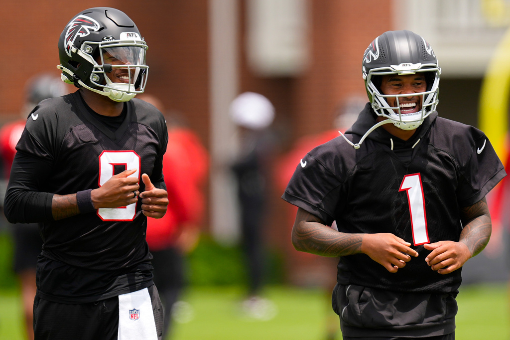 FILE - Atlanta Falcons quarterback's Michael Penix Jr. and Tua Tagovailoa (1) move during an NFL football practice, Wednesday, May 27, 2026, in Flowery Branch, Ga. (AP Photo/Mike Stewart, File)