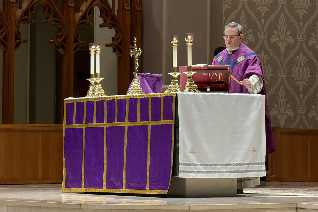 A Roman Catholic priest says a prayer during an afternoon Mass at the Cathedral of Saints Peter and Paul, which serves as the home church of the Roman Catholic Diocese of Providence, on Thursday, March 5, 2026, in Providence, R.I. (AP Photo/Rodrique Ngowi)