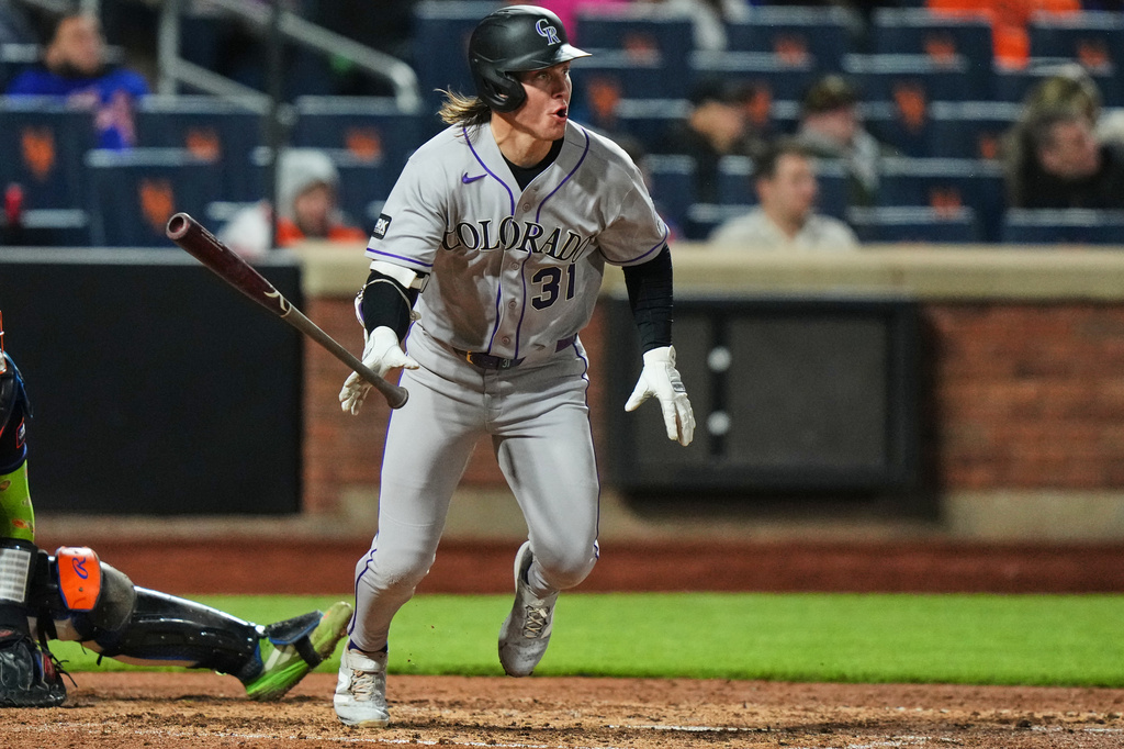 Colorado Rockies' Jake McCarthy (31) follows through on a RBI double during the sixth inning of a baseball game against the New York Mets Friday, April 24, 2026, in New York. (AP Photo/Frank Franklin II)