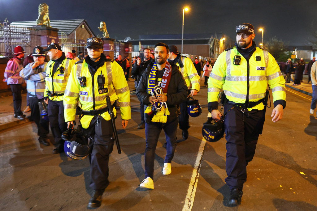 Maccabi Tel Aviv's fan is escorted by police ahead of the Europa League soccer match between Aston Villa and Maccabi Tel Aviv in Birmingham, England, Thursday, Nov. 6, 2025. (AP Photo/Darren Staples)