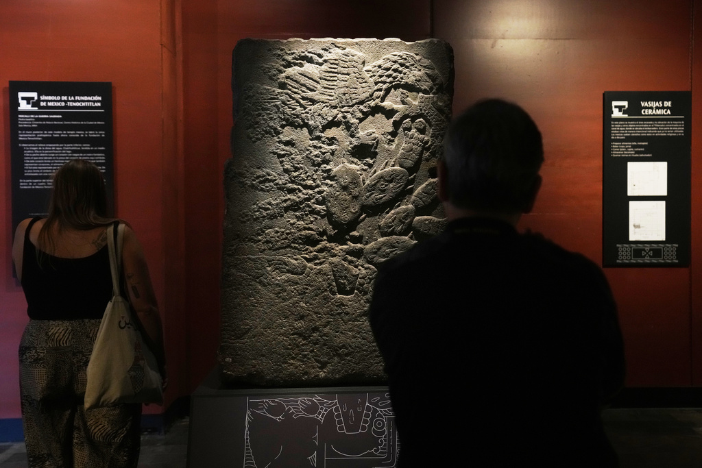 The Teocalli of the Sacred War, the only archaeological piece bearing the carved symbol of Tenochtitlan's founding, an eagle perched on a cactus, is on display at the National Museum of Anthropology in Mexico City, Friday, Nov. 14, 2025. (AP Photo/Claudia Rosel)