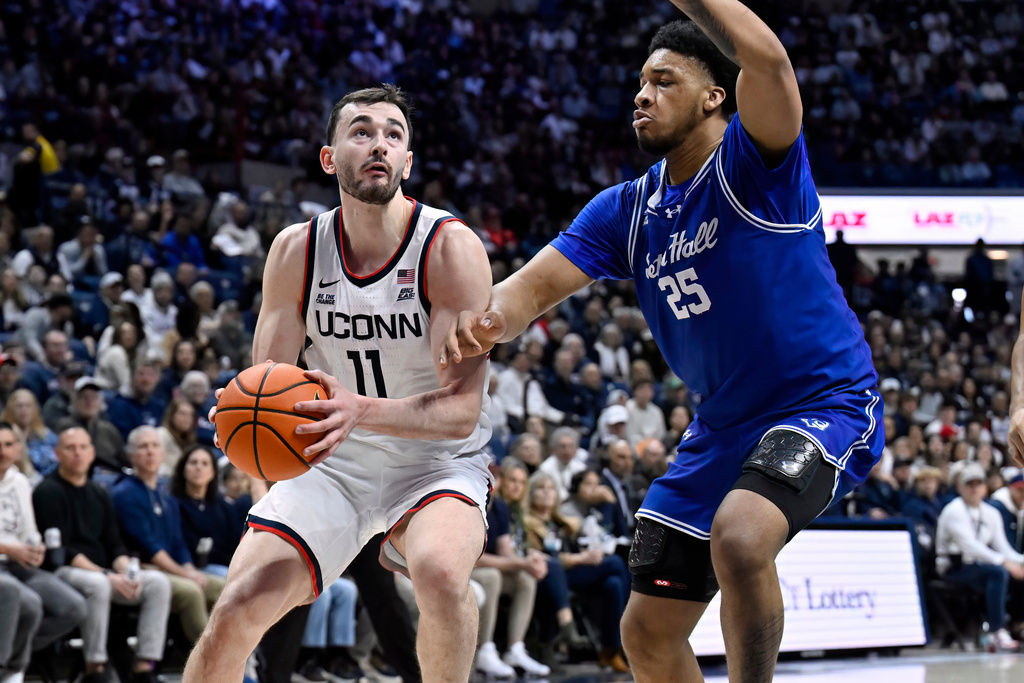 UConn forward Alex Karaban (11) looks to shoot as Seton Hall center Najai Hines (25) defends in the first half of an NCAA college basketball game, Saturday, Feb. 28, 2026, in Storrs, Conn. (AP Photo/Jessica Hill)