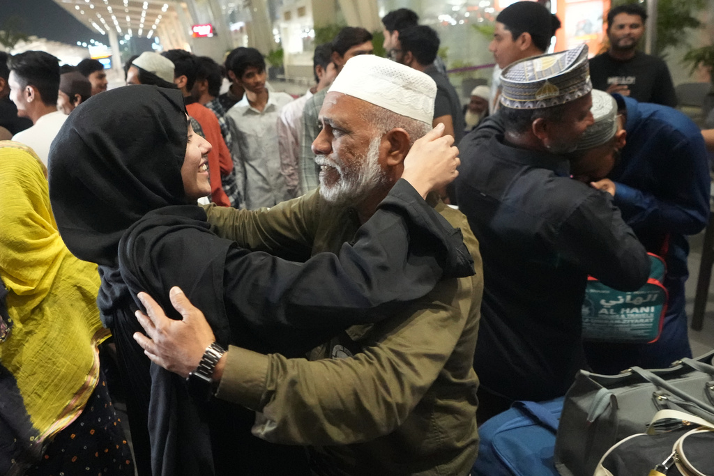 A man, center right, breaks down as he hugs a relative at airport upon his arrival from Jeddah, in Ahmedabad, India, Wednesday, March 4, 2026. (AP Photo/Ajit Solanki)