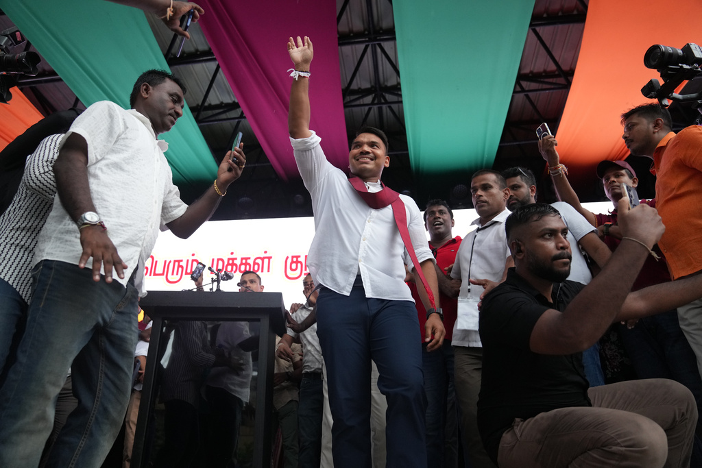 Sri Lankan lawmaker Namal Rajapaksa, heir to the once-powerful Rajapaksa dynasty, waves to supporters during a public rally in Colombo, Sri Lanka, Friday, Nov. 21, 2025. (AP Photo/Eranga Jayawardena)