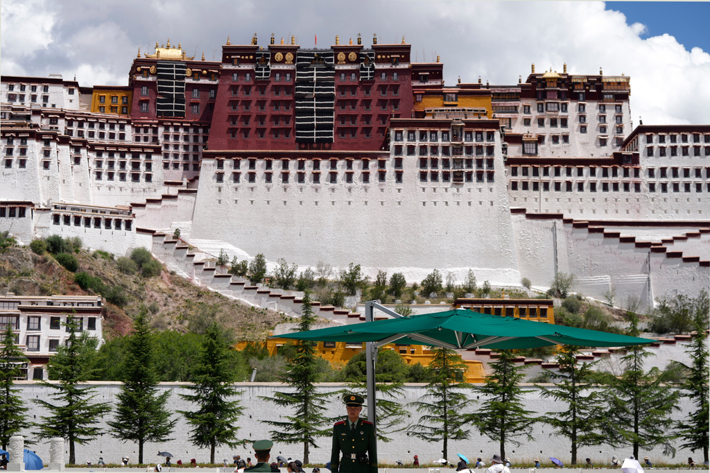 A Chinese paramilitary policeman stands on guard on a square in front of the Potala Palace in Lhasa in western China's Tibet Autonomous Region on Tuesday, July 21, 2026, as seen during a government organized visit for foreign journalists. (AP Photo/Ng Han Guan)
