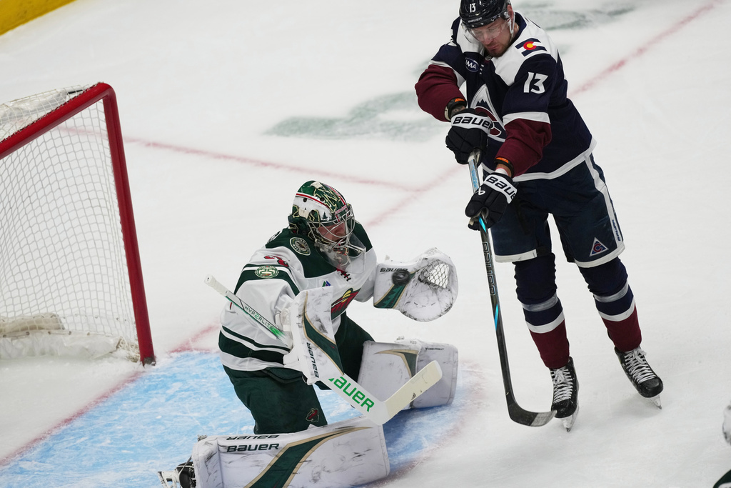 Colorado Avalanche right wing Valeri Nichushkin, right, redirects the puck at Minnesota Wild goaltender Filip Gustavsson, left, in the first period of an NHL hockey game Thursday, Feb. 26, 2026, in Denver. (AP Photo/David Zalubowski)