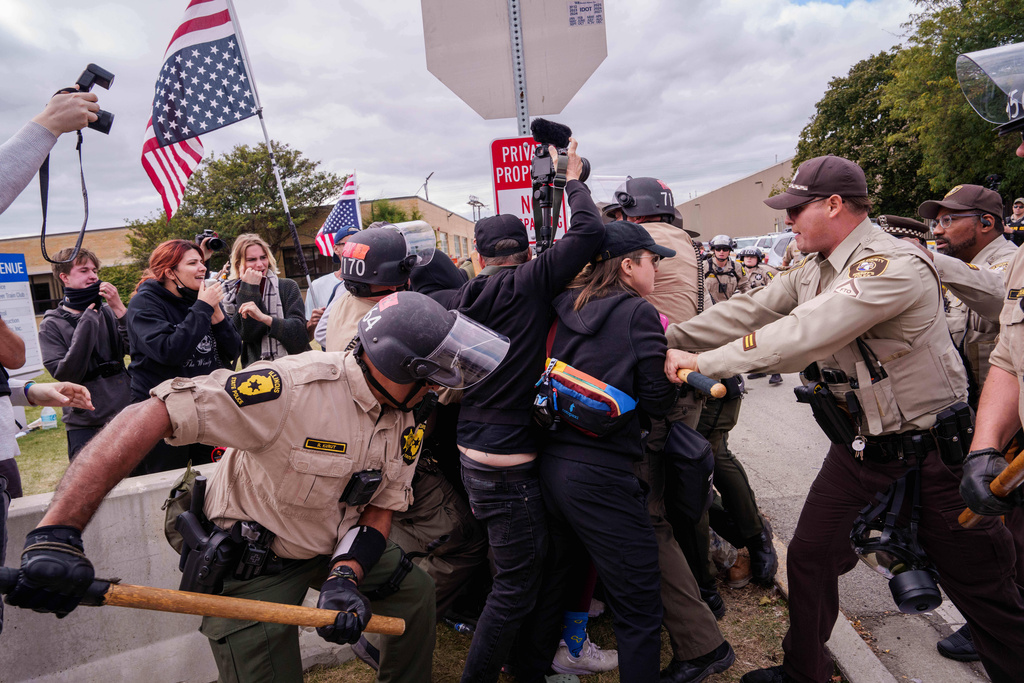Illinois State Police and Cooks County Sheriffs move in to detain protesters outside the U.S. Immigration and Customs Enforcement facility in Broadview, Ill., Saturday, Oct. 11, 2025. (AP Photo/Adam Gray)
