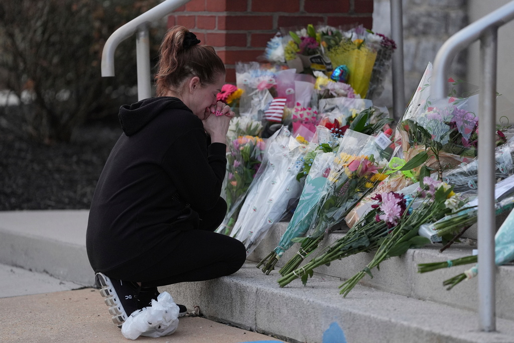 FILE - Linda Shields leaves flowers in front of the West York Police Department after a police officer was killed responding to a shooting at UPMC Memorial Hospital in York, Pa. on Feb. 22, 2025. (AP Photo/Matt Rourke, File)