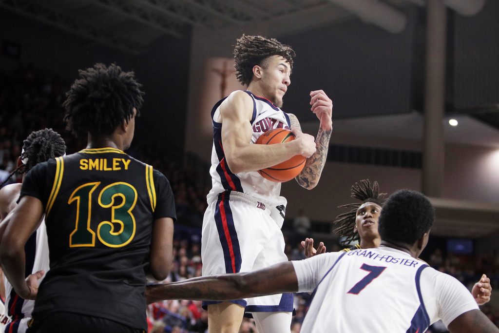 Gonzaga guard Jalen Warley, center, grabs a rebound during the first half of an NCAA college basketball game against San Francisco, Saturday, Jan. 24, 2026, in Spokane, Wash. (AP Photo/Young Kwak)