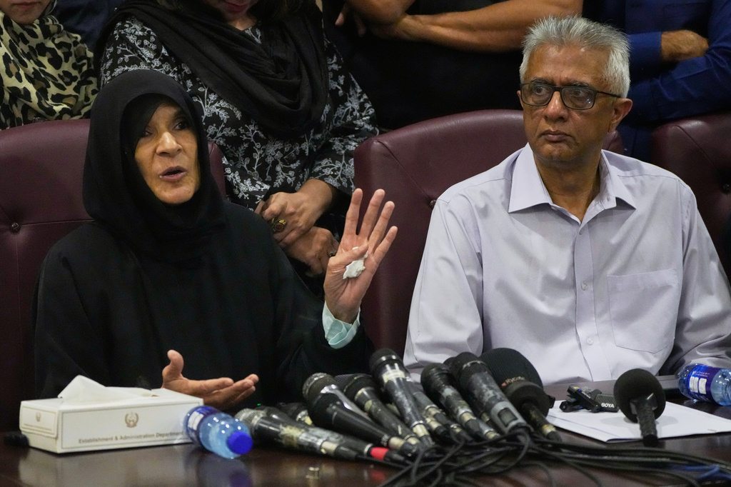 Former Pakistani Prime Minister Imran Khan's sister Uzma Khan, left, speaks as Khan's personal physician Faisal Sultan watches during a press conference in Islamabad, Pakistan, Friday, Aug. 21, 2026. (AP Photo/Anjum Naveed)