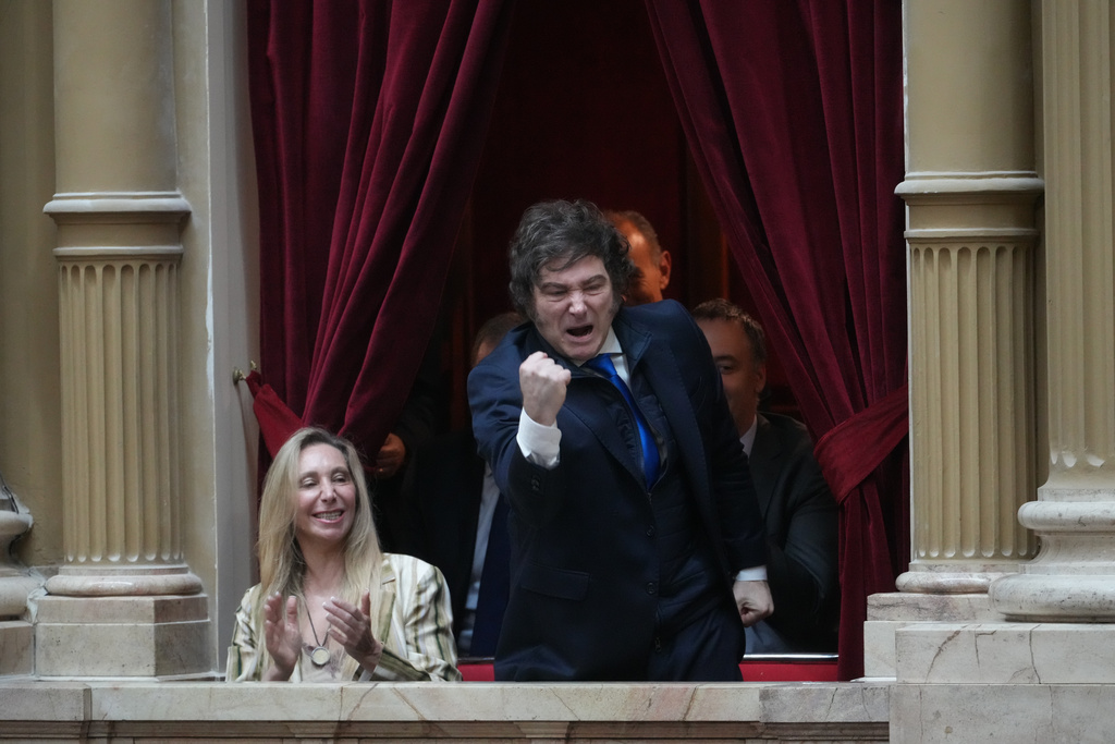 Argentine President Javier Milei, right, and General Secretary of the Presidency Karina Milei, his sister, cheer for their party's lawmakers during the swearing-in ceremony for newly elected legislators at Congress in Buenos Aires, Argentina, Wednesday, Dec. 3, 2025. (AP Photo/Rodrigo Abd)