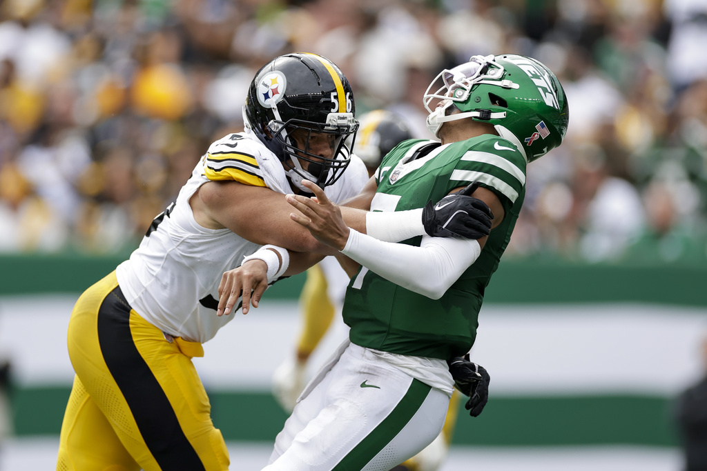 New York Jets quarterback Justin Fields, right, takes a hit from Pittsburgh Steelers linebacker Alex Highsmith after throwing a pass during the second half of an NFL football game Sunday, Sept. 7, 2025, in East Rutherford, N.J. (AP Photo/Adam Hunger)