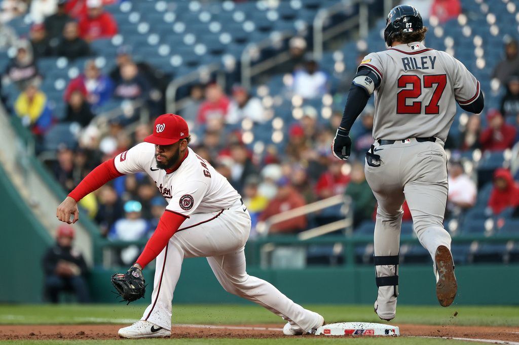 Washington Nationals first baseman Luis Garcia Jr., left, catches the ball for an out against Atlanta Braves' Austin Riley (27) during the second inning of a baseball game, Monday, April 20, 2026, in Washington. (AP Photo/Daniel Kucin Jr.)