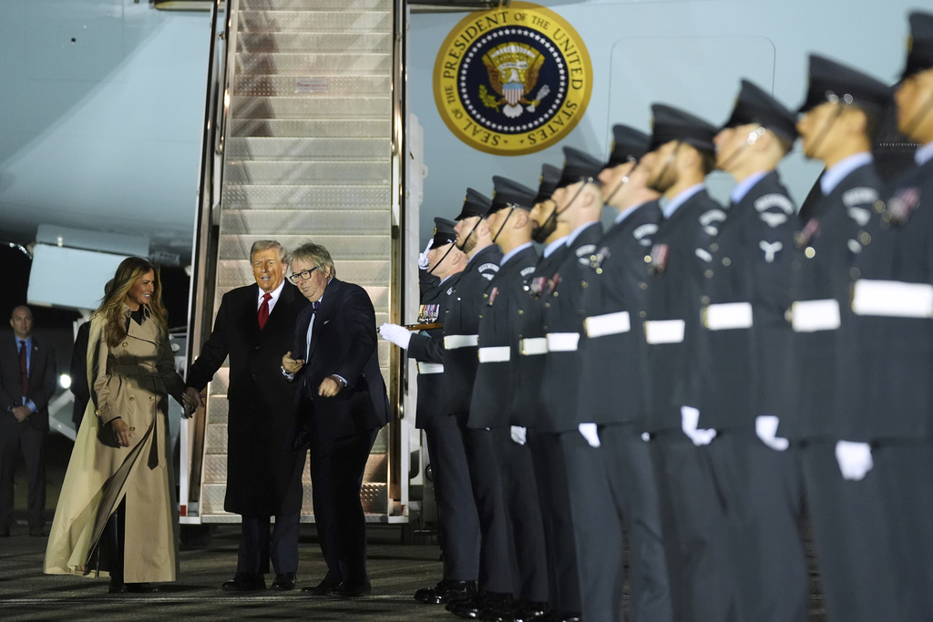 President Donald Trump and first lady Melania Trump are greeted by The Viscount Hood, Lord-in-Waiting, center, right, as they arrive at Stansted Airport near London, Tuesday, Sept. 16, 2025. (AP Photo/Evan Vucci)