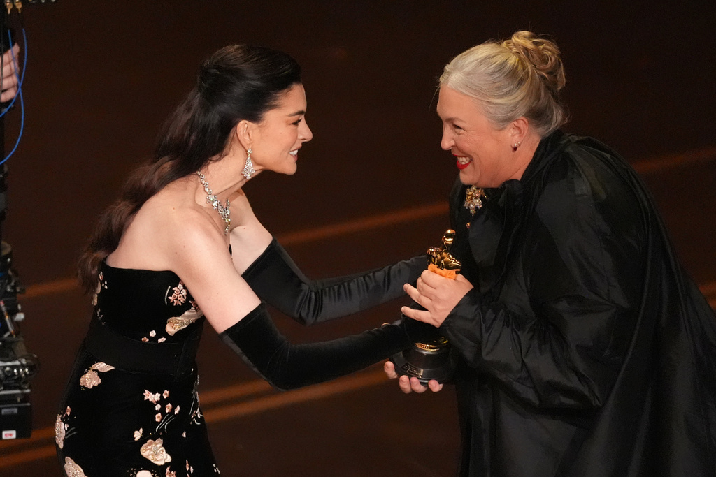 Anne Hathaway presents the award for best costume design to Kate Hawley for "Frankenstein" during the Oscars on Sunday, March 15, 2026, at the Dolby Theatre in Los Angeles. (AP Photo/Chris Pizzello)