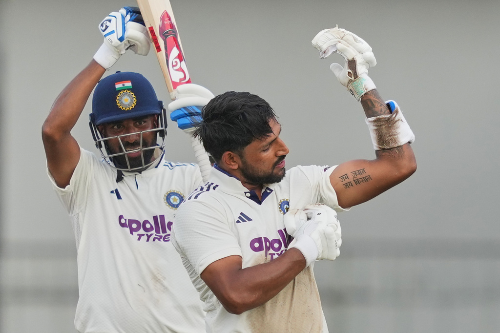 India's Dhruv Jurel celebrates his century as batting partner India's Mohammed Siraj, left, watches during day two of the second cricket test match between Sri Lanka and India in Colombo, Sri Lanka, Monday, Aug. 24, 2026. (AP Photo/Eranga Jayawardena)