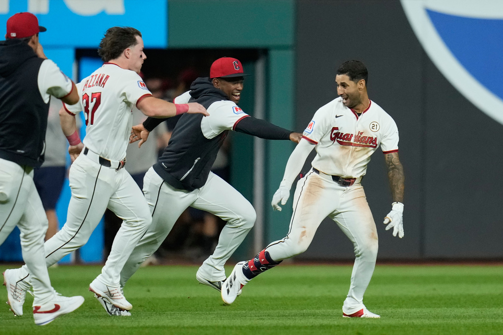 Cleveland Guardians' Brayan Rocchio, right, celebrates with teammates after hitting a game winning double in the ninth inning of a baseball game against the Chicago White Sox in Cleveland, Tuesday, Sept. 15, 2026. (AP Photo/Sue Ogrocki)