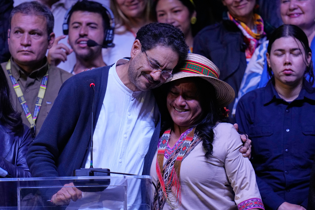 Presidential candidate Ivan Cepeda of the ruling Historic Pact coalition embraces his vice-presidential running mate, Aida Quilcue, during an election night appearance after election results showed him trailing in Bogota, Colombia, Sunday, June 21, 2026. (AP Photo/Fernando Vergara)
